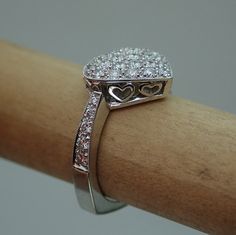 "This pave diamond heart shape ring is hand made in 18k white gold. There are 36 Pave set side diamonds totaling .76Cts, approximately 3/4 Carat The diamonds are VS clarity and G color range. We make all our own jewelry and focus on quality and durability. The ring is currently a size 6.25 you will be able to return it within the listed time frame for any reason at all. It will take 1-2 business days processing time. We can size it any size from 5 to 7 but it would be a FINAL SALE. It will take Diamond Heart Cut Ring Hallmarked, Heart-shaped Hallmarked Diamond Ring, Wedding Heart Ring With Hallmarked Diamond, Diamond White Heart Ring With Pave Setting For Anniversary, Hallmarked Heart-shaped Diamond Ring For Anniversary, Luxury Pave Setting Heart Ring For Anniversary, Pave Setting Heart Ring For Anniversary, Round Heart Ring With Pave Setting For Anniversary, Heart Cut Diamond Ring With Pave Setting For Anniversary