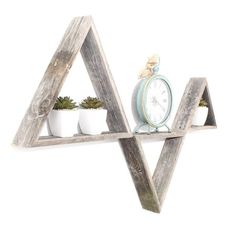 two wooden shelves with plants and a clock