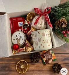 a christmas gift box filled with cookies, candies and other holiday treats on a wooden table