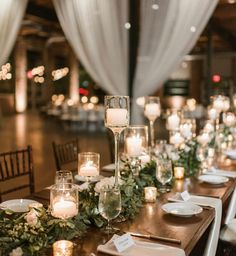 a long table with candles, plates and napkins is set up for an event