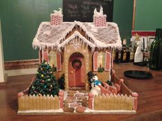 a gingerbread house decorated with icing and decorations