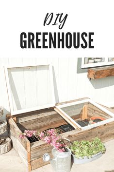 an old wooden box filled with flowers sitting on the side of a building that says diy greenhouse