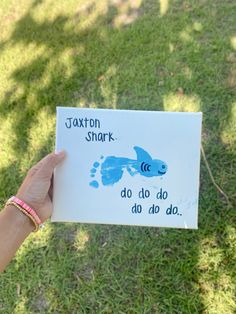 a hand holding up a card that says saxon shark do do do do