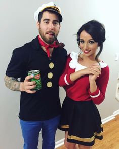 a man and woman dressed in costumes posing for the camera with beer cans on their feet