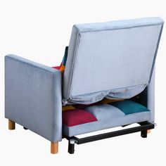 a blue chair with multi colored cushions on it