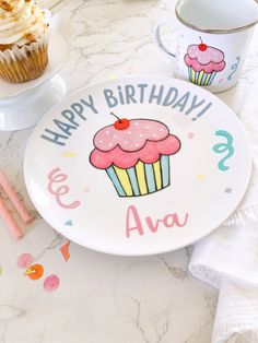 a plate with a cupcake on it and the words happy birthday violett written in pink