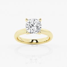 a yellow gold engagement ring with a round diamond in the center, on a white background