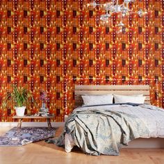 a bedroom with an orange wallpaper and bed in the corner, next to a chandelier