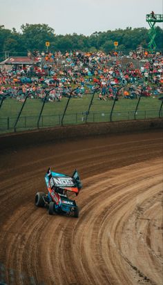 a person riding a buggy on top of a dirt track