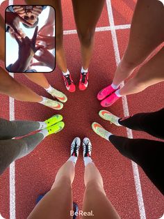 several people standing in a circle with their feet on the ground and one person wearing pink shoes