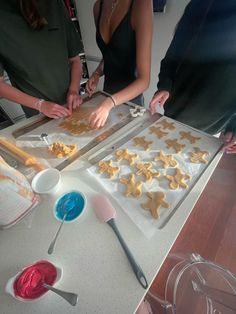 some people are making cookies on a table