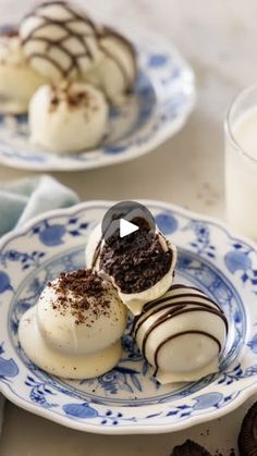 two plates with desserts on them next to a glass of milk