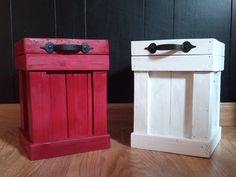 two red and white wooden boxes sitting on top of a hard wood floor next to each other