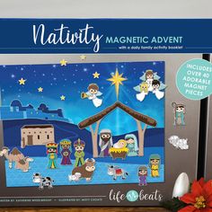 a christmas scene with nativity magnets in front of it