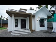 a small white house with black doors and windows