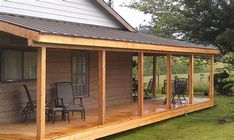 a large wooden porch with chairs on the front and side of it next to a house