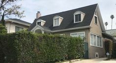 a house with hedges on the front and side