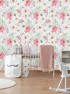 a baby's room with floral wallpaper, rocking chair and crib in front of it