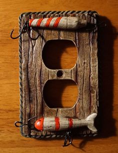 an old wooden switch plate with a red and white striped handle