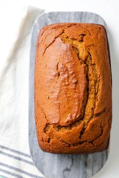 a loaf of pumpkin bread sitting on top of a towel