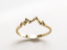 mountain 14k Solid Gold Ring, Casual Elegant Accessories, Minimal Style Ring, Jewelry For Mountain Lover, Handcrafted Jewelry for Birthday Metal: 14K Solid Gold. Rail width: 1.1 mm. A delicate ring, depicting a minimalist motif of a mountain panorama. The whole piece has been polished to a high shine highlighting the delicate hand carvings while emphasizing the warm shade of gold. Jewelry is sent in an elegant box for safe transport and easy gifting. Handmade in our Krakow studio using traditional and modern techniques.  ALL RINGS ARE SUBJECT TO SIZE ADJUSTMENTS IN THE PURCHASE PRICE, UP TO A MAXIMUM OF ONE MONTH AFTER PURCHASE. REALIZATION TIME 5- 7 WORKING DAYS + SHIPPING TIME Accessories Minimal, Mountain Panorama, Minimalist Mountain, Casual Rings, Mountain Lover, Solid Gold Ring, Shades Of Gold, Minimal Style, Elegant Accessories