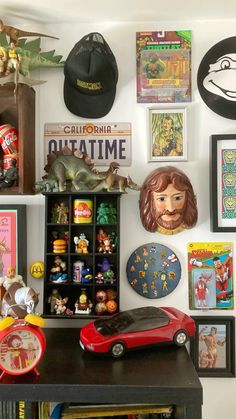 there are many pictures and toys on the wall