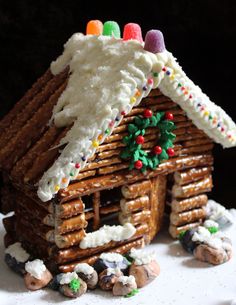 a gingerbread house made out of pretzel and icing is featured on instagram