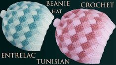 two crocheted hats sitting next to each other on top of a black surface