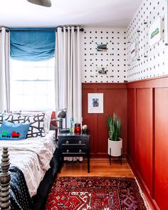 a bed room with a neatly made bed and a rug