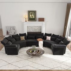 a living room filled with black couches and a white rug on top of a hard wood floor