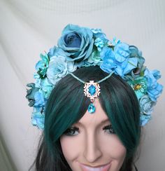 Blue fairy Flower Crown Fascinator. Blue Flower Headband Fascinator. Water Fairy, Fantasy, Mermaid. This spectacular, lush flower crown, is made of flowers, roses, a beautiful jeweled centerpiece. Feminine and pretty this headdress is ideal for making a statement. It can be a great addition to any fairy fantasy costume . Can be used as a pagan, carnival headpiece, for a garden weddingor tribal headpiece . It is lightweight, comfortable to wear and beautiful from the back view as well. Based upon Adjustable Blue Costume Accessories For Costume Party, Bohemian Blue Headpiece For Party, Blue Bohemian Headpieces For Party, Bohemian Blue Headpieces For Party, Blue Bohemian Party Headpiece, Whimsical Blue Costume Hats And Headpieces For Festival, Blue Headband With Handmade Flowers, Adjustable Blue Headpieces For Festivals, Adjustable Blue Festival Headpieces