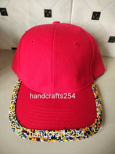 This is a beaded baseball hat. It's an adult sized hat which has an adjustable strap at the back. American Hat, Beaded Hat, Bead Caps, Baseball Hat, Trucker Cap, Kenya, Primary Colors, Caps Hats, Native American