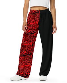 Get ready to rave in ultimate comfort with the Hypnotic Split Wide Leg Pants. These pants bring all the chill vibes of your favorite sweatpants but with way more style. Featuring a bold red and black split design with trippy wavy patterns on one leg, these pants are perfect for making a statement at Lost Lands, Bass Canyon, or your next rave. Relaxed unisex fit for all-day comfort, whether you're dancing or lounging Handy side pockets to stash your essentials while you vibe out Elastic waistband Red Wide Leg Sweatpants For Streetwear, Trendy Red Pants With Elastic Waistband, Trendy Red Sweatpants For Streetwear, Casual Red Summer Sweatpants, Edgy Black Bottoms For Loungewear, Trendy Black Sweatpants With Loosely Fitted Hips, Trendy Black Sweatpants With Loose Fit Hips, Trendy Red Loungewear Bottoms, Edgy Red Pants For Streetwear