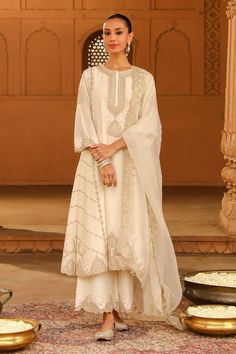 Daisy ivory silk chanderi A-line kurta with kashmiri tilla and parsi gara embroidery. Comes with palazzo and a silk organza dupatta. - Aza Fashions Cream Dola Silk Sets With Traditional Drape, White Raw Silk Dress With Cutdana, Off White Silk Set With Intricate Embroidery, Wedding Palazzo Set With Intricate Embroidery In Cream, Elegant Off White Raw Silk Sets, Off White Georgette Palazzo Set With Dupatta, Cream Palazzo Set With Resham Embroidery For Wedding, Beige Chanderi Sharara For Wedding, Beige Resham Embroidery Palazzo Set For Wedding