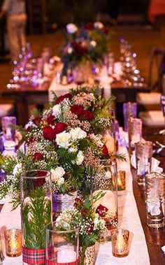 the table is set with many different types of flowers and candles for an elegant dinner