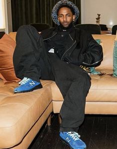 a man sitting on top of a couch in a living room