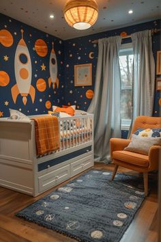 a baby's room decorated in blue, orange and white with space themed wallpaper