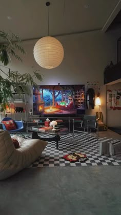 a living room filled with furniture and a large screen tv on top of a wall