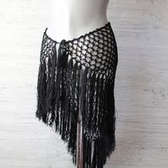 Add a touch of drama to your dance ensemble with this black triangle skirt.  This hip scarf features a bold fish net design that beautifully accentuates your moves.  The elegant black fringes sway with every step, creating a mesmerizing effect. Made from soft, breathable cotton yarn, this versatile dance festival hip wrap offers comfort and flexibility, ensuring it stays in place while you perform. *Size: Black triangle skirt has length including fringe 21.6" (55 cm) Width of the triangle part i Hip Scarf, Scarf Skirt, Black Ruffled Festival Skirt, Crochet Belly Dance Skirt, Triangle Skirt, Fishnet Skirt, Siren Costume, Belly Dancing Hip Scarf, Black Fringe Beachwear Cover-up