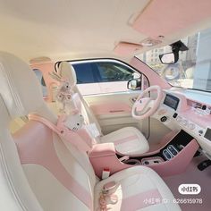 the interior of a pink and white car