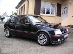 a black car parked in front of a house