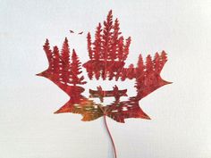 a red leaf that is floating in the water