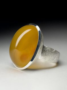 Big scratched silver ring with natural cabochon cut Carnelian stone measurements - 0.51 x 0.55 x 0.87 in / 13 x 14 x 22 mm stone weight - 25.4 carats ring size - 9.25 US / 60 EU / 19.25 ring weight - 13.28 grams ref No 5307 Worldwide shipping from Berlin, Germany Modern Domed Cabochon Rings, Modernist Round Cabochon Jewelry, Modernist Oval Cabochon Rings, Modern Oval Cabochon Opal Ring, Modern Orange Oval Rings, Polished Agate Oval Cabochon Rings, Modern Chalcedony Jewelry With Polished Finish, Modern Rings With Large Oval Cabochon Stone, Oval Cabochon Agate Ring With Polished Finish