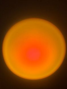 an orange and yellow circular object in the sky