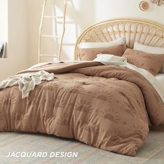 a bed with brown comforter and pillows in a room