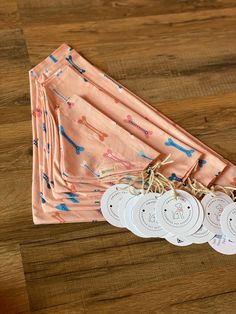 four napkins and three tags on a wooden table