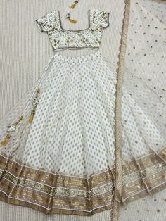 Ivory Designer Fully Customised Lehenga Choli Specification Lehenga Lehenga Fabric : Banarasi Gerogette silk Lehenga Closer: Drawstring, Attached Tussle  Flair: 3.5 Meter Inner: Cotton Skirt Style: Customized  Blouse Blouse Fabric: Raw Silk Blouse Work: Sequins, Kasab, Zardosi Blouse Neck: Fully Customized  Dupatta Dupatta Finish Type: Heavy Lace, Sequins, Kasab, Zardosi Dupatta Fabric: Soft Net Package Contain: Lehenga, Blouse and Dupatta, Drawstring, Tussle  Our products are 100% authentic and White Dress For Navratri With Traditional Drape, Traditional White Wedding Dress With Drape, Traditional White Wedding Dress For Festive Season, Beige Floor-length Party Sets, Traditional White Gown With Pallu, White Traditional Drape Dress For Diwali, White Traditional Drape Dress For Festivals, White Anarkali Dress For Wedding, Traditional Drape White Dress For Diwali