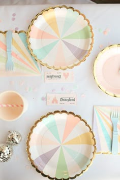 a table set up with plates, napkins and utensils