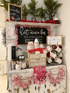 an old dresser is decorated with christmas decorations and coffee mugs for sale at the store