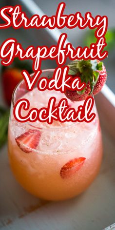 a strawberry grapefruit vodka cocktail in a glass with strawberries on the rim